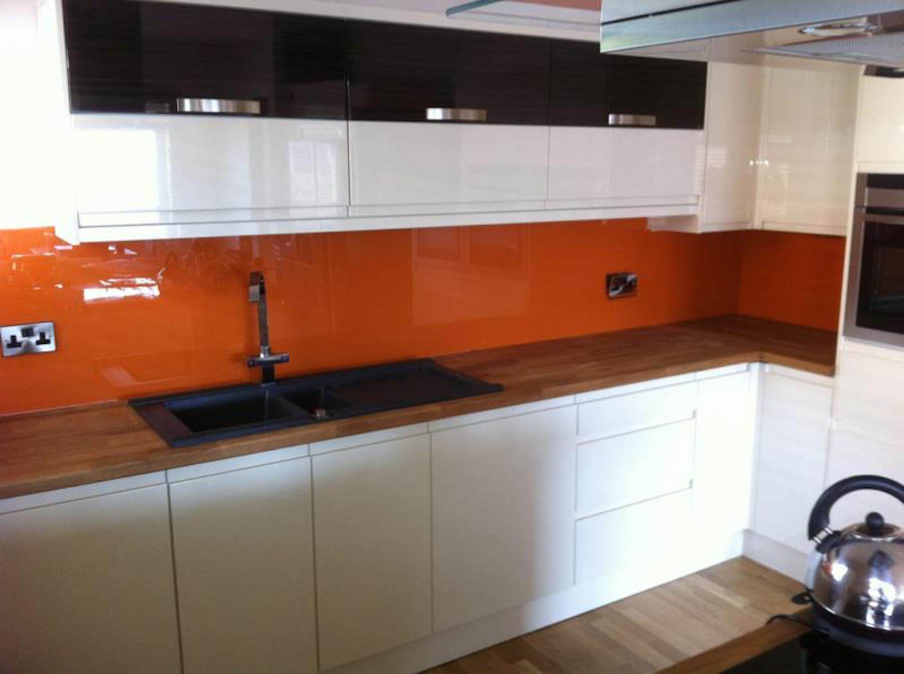 Orange splash backs in kitchen